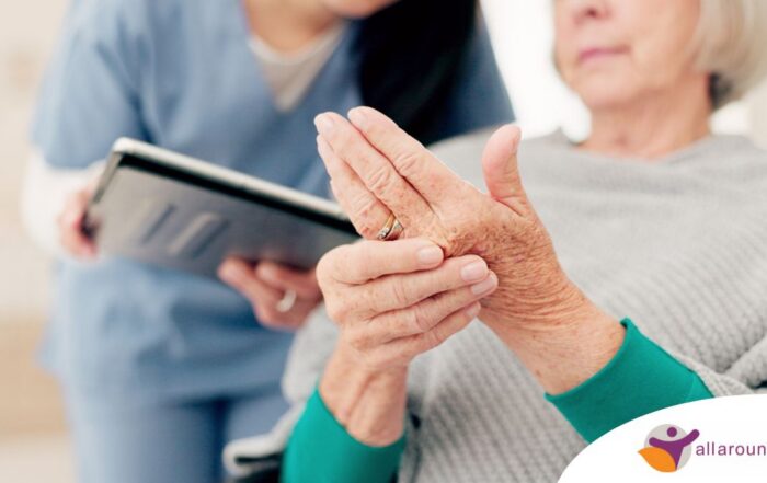 A caregiver provides in home care services to a senior with arthritis