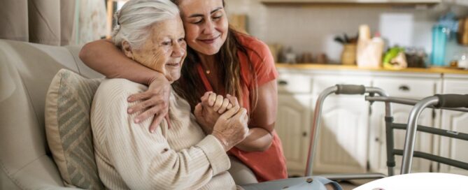 Caregiver supporting an elderly woman in the transition to senior home care